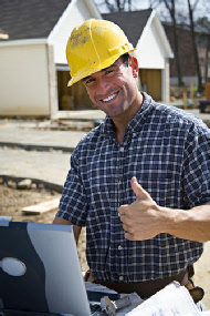 Contractor with a hard hat and tools giving a thumbs up